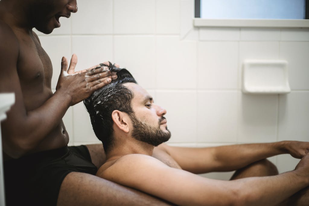 Man Washing Another Man's Hair